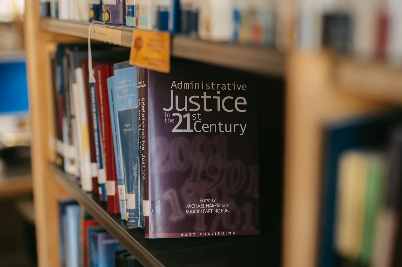 A book about administrative justice is on a shelf