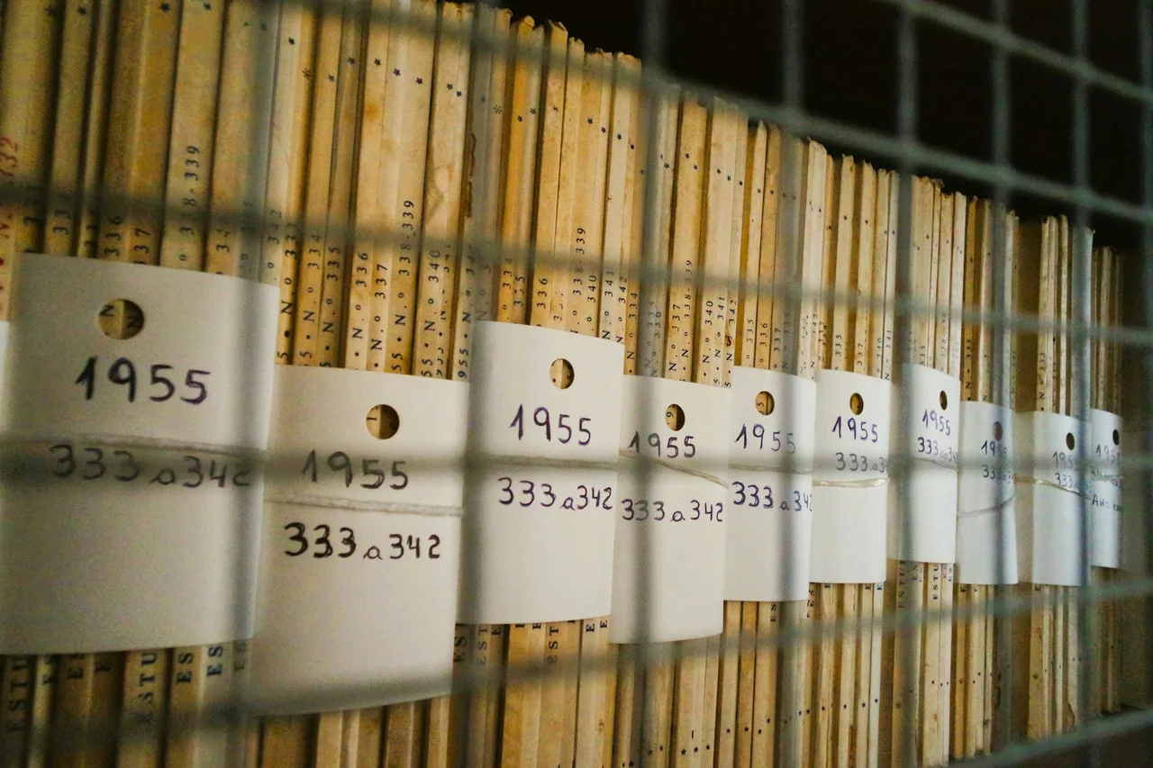 A group of white signs on an archival rack