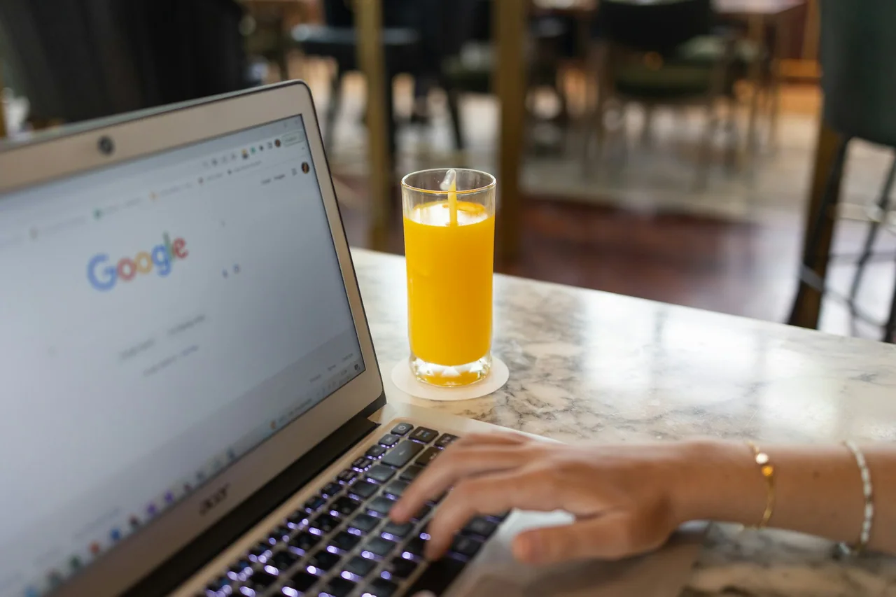 A person uses a laptop at a table