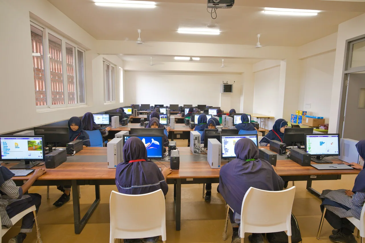 Students work at desktop computers in a school computer laboratory