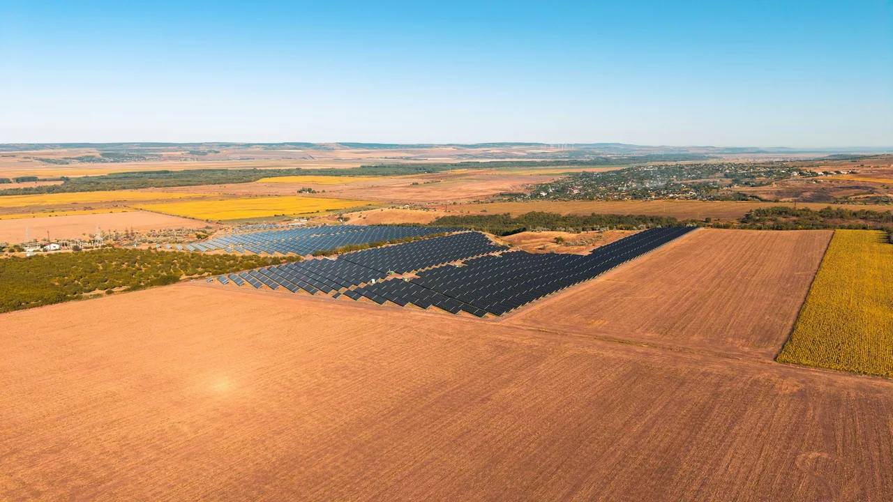 An aerial view of a large solar panel field.