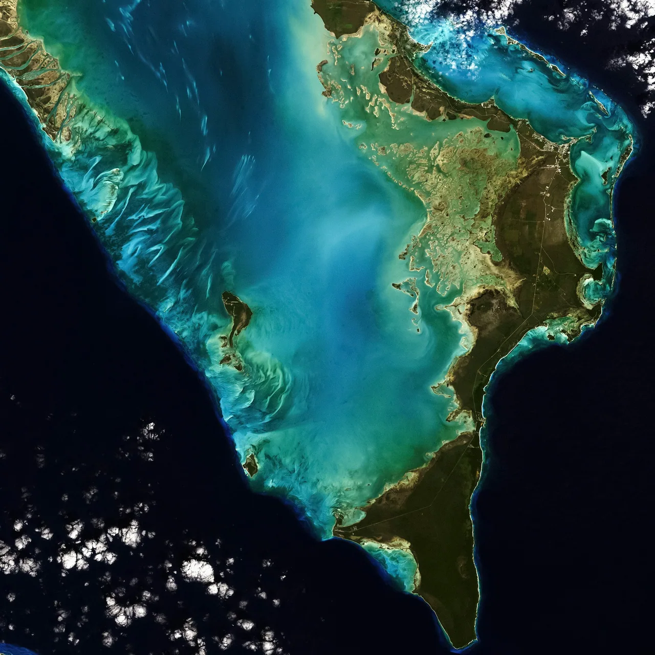 Satellite view of islands and turquoise coastal waters.