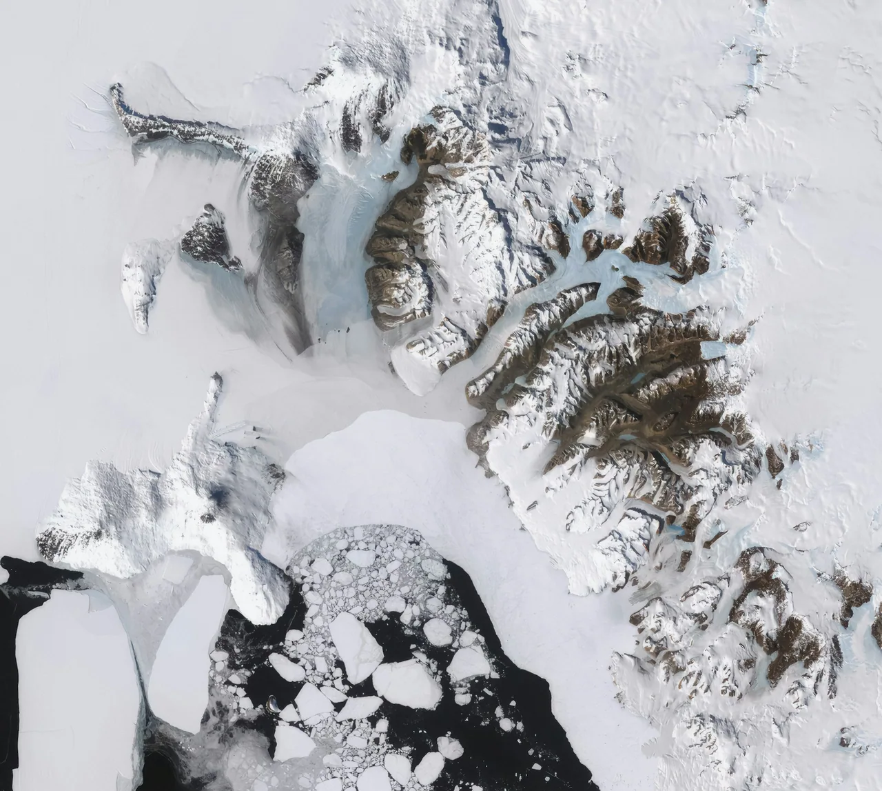 Satellite image of Antarctic mountain ranges and ice.