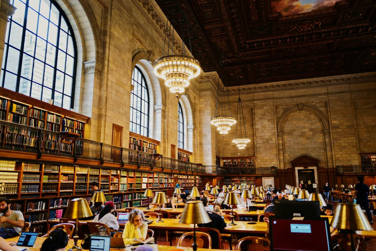 Readers using laptops in a public library