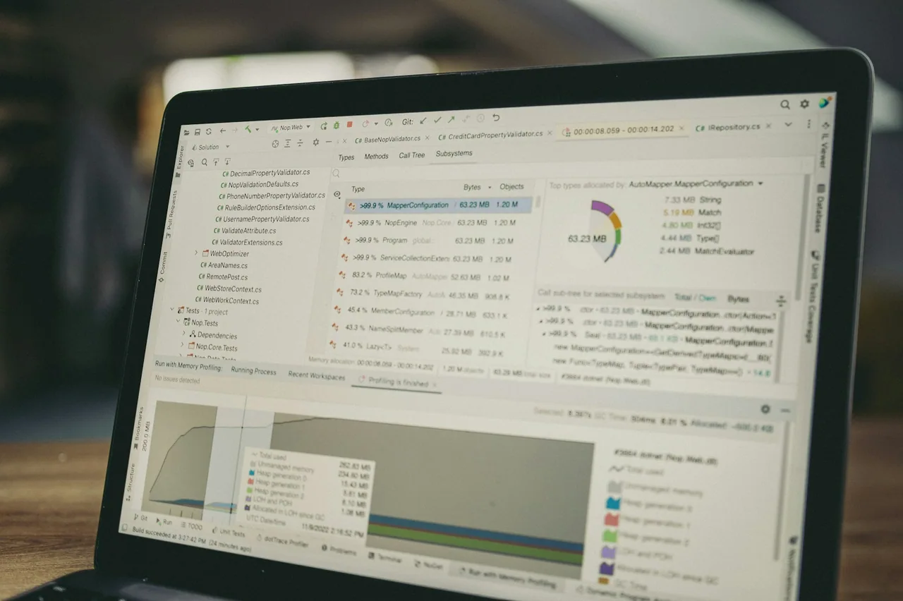 Laptop screen showing source code and data charts